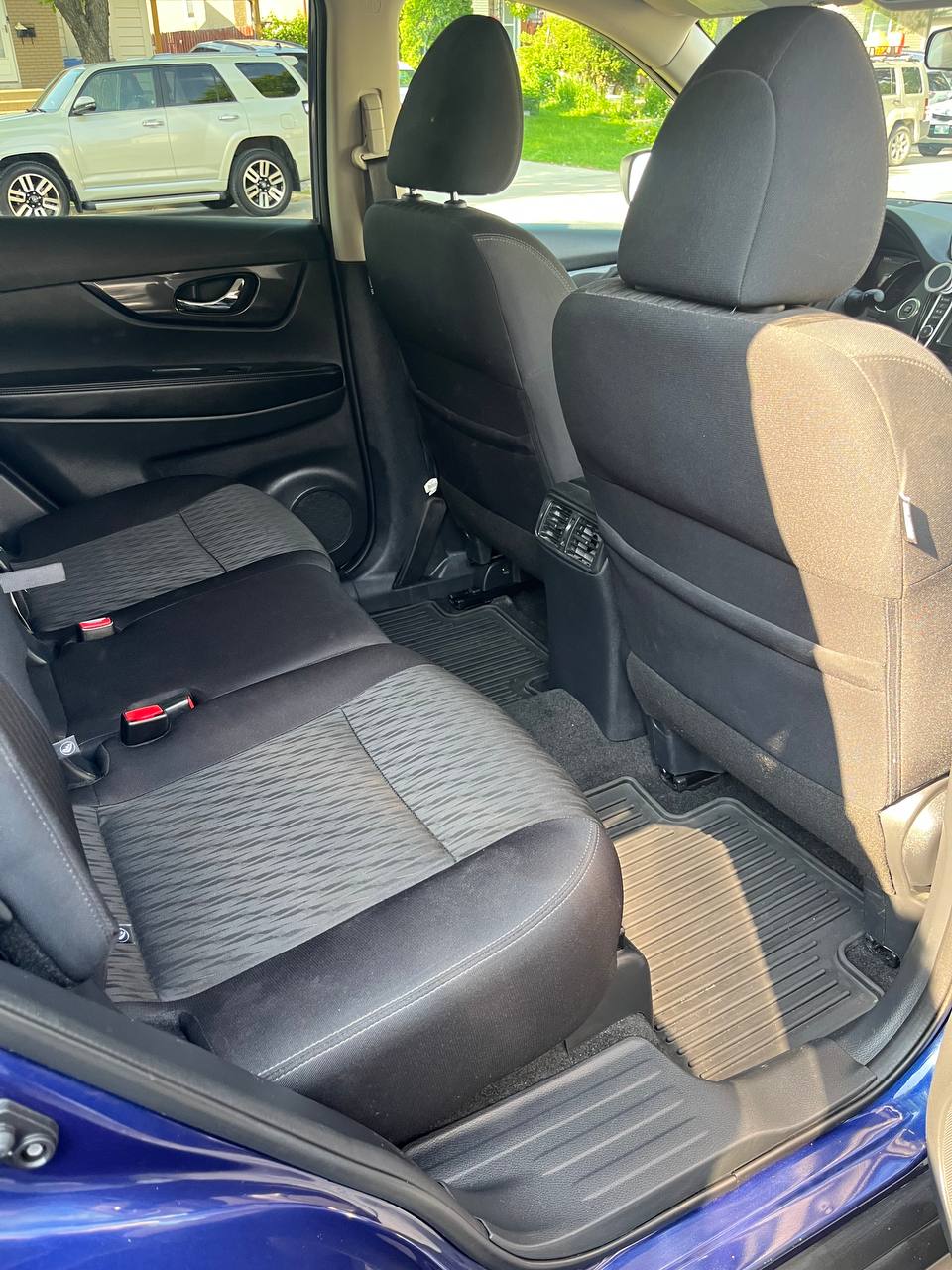 The same rear bench after cleaning, the cloth seats vacuumed and the rear mats clear of debris